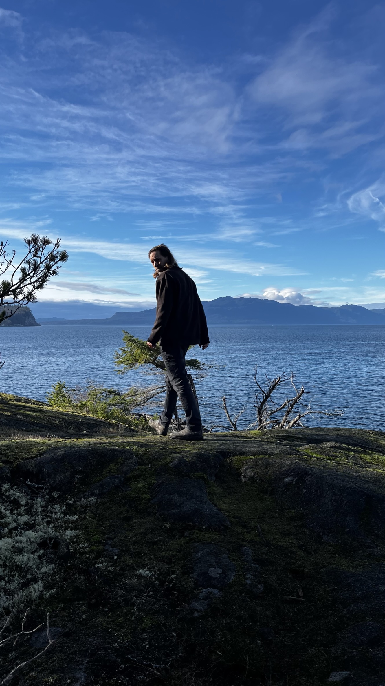 Sam at Smuggler Cove with the distant Salish Sea